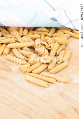 Homemade raw apulian pasta background of italian pasta called Orecchiette and Maccheroni typical dish of Southern Italy, region of Puglia, Salento. Homemade raw apulian pasta background of italian pasta called Orecchiette and Maccheroni typical dish of Southern Italy, region of Puglia, Salento. 62937427