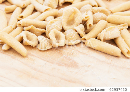 Homemade raw apulian pasta background of italian pasta called Orecchiette and Maccheroni typical dish of Southern Italy, region of Puglia, Salento. Homemade raw apulian pasta background of italian pasta called Orecchiette and Maccheroni typical dish of Southern Italy, region of Puglia, Salento. 62937430