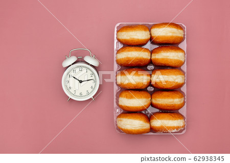 traditional polish donuts in a box and alarm clock traditional polish donuts in a box and alarm clock 62938345