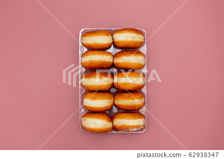 traditional polish donuts in a box on pink 62938347