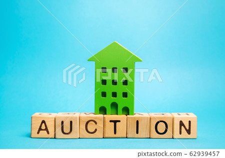 Wooden blocks with the word Auction and miniature house. Real estate public sale concept. Auction method of selling housing. Buying, foreclosure of apartment. Trade Wooden blocks with the word Auction and miniature house. Real estate public sale concept. Auction method of selling housing. Buying, foreclosure of apartment. Trade 62939457