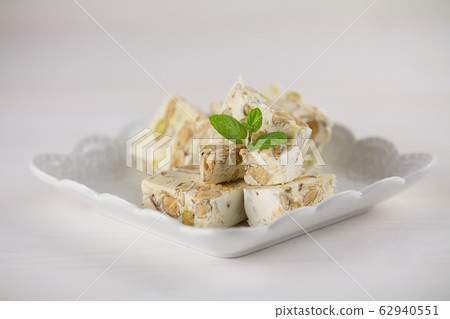 Hazelnut torrone or nougat from Apulia on the white background, selective focus 62940551