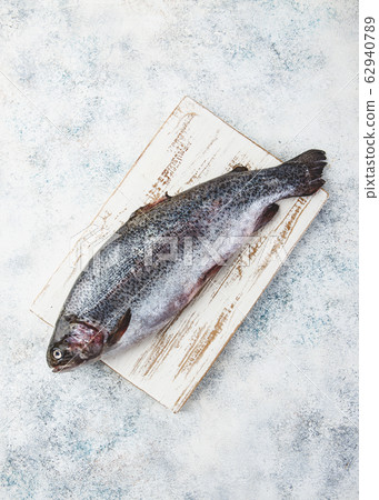 Raw rainbow trout light background 62940789