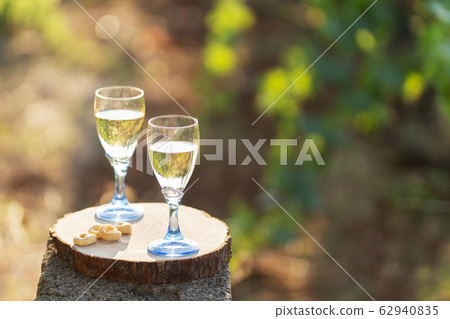 Two glasses of fresh white wine on a wooden board 62940835