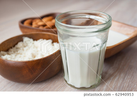 Homemade almond milk in a glass, almonds, milk and Homemade almond milk in a glass, almonds, milk and 62940953