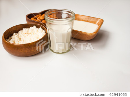 Homemade almond milk in a glass, almonds, milk and Homemade almond milk in a glass, almonds, milk and 62941063