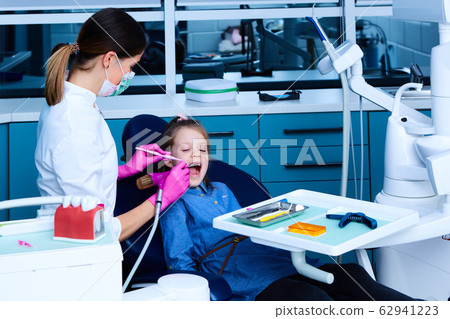 Young female dentist working in her office. 62941223