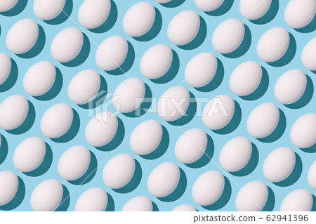 White eggs on light blue background. White eggs on light blue background. 62941396