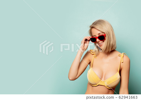 Beautiful blonde woman in yellow bikini and Beautiful blonde woman in yellow bikini and 62941663