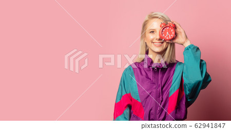 Beautiful blonde woman in 90s clothes with alarm 62941847