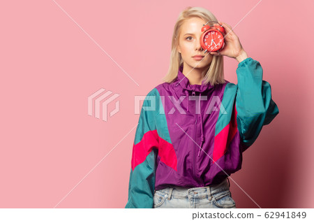 Beautiful blonde woman in 90s clothes with alarm 62941849