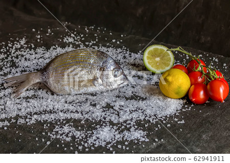 Fresh raw italian dorado with tomatoes and lemon Fresh raw italian dorado with tomatoes and lemon 62941911