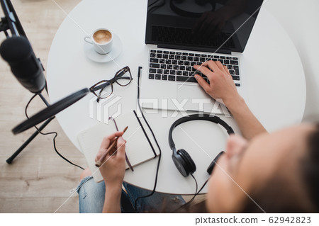 Woman blogger recording radio podcast in studio. Woman blogger recording radio podcast in studio. 62942823