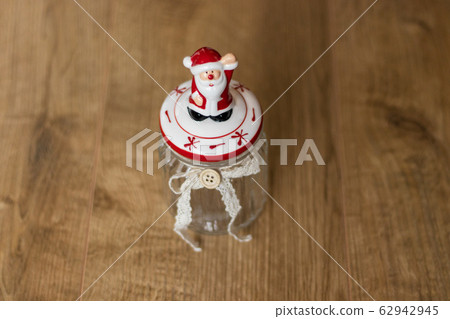 Porcelian Santa Claus on transparent Christmas jar 62942945