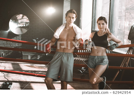 Portrait of a couple of boxers having a good time during training in a boxing gym and smiling 62942954