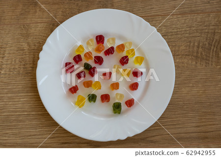 Delicious Jelly Bears on white plate top view Delicious Jelly Bears on white plate top view 62942955