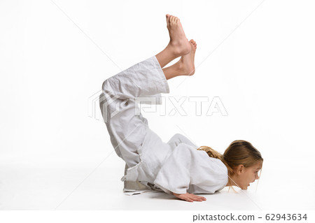 Girl judo student performs warm-up 62943634