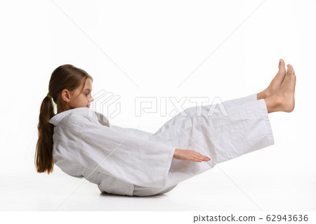 Girl judoka performs warm-up and reaches her hands Girl judoka performs warm-up and reaches her hands 62943636
