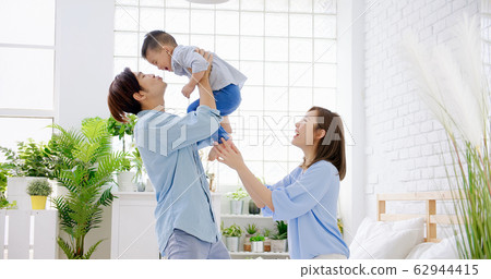 Happy family kiss their child 62944415