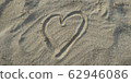 A heart drawn on a sandy beach 62946086