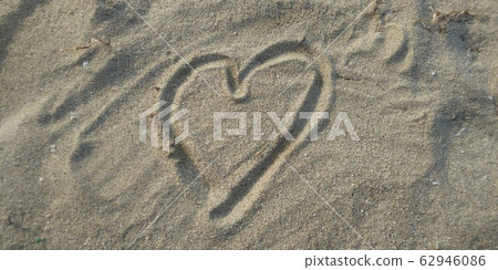 A heart drawn on a sandy beach A heart drawn on a sandy beach 62946086