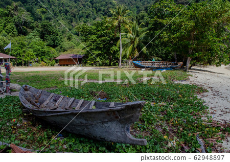 rowboat used by the moken, Old boat in moken village, Surin Island, Thailand rowboat used by the moken, Old boat in moken village, Surin Island, Thailand 62948897