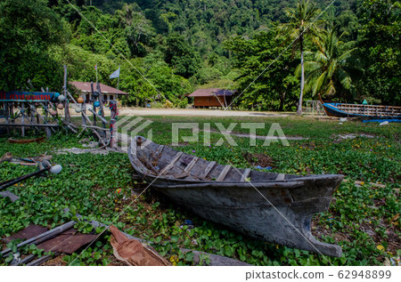 rowboat used by the moken, Old boat in moken village, Surin Island, Thailand rowboat used by the moken, Old boat in moken village, Surin Island, Thailand 62948899