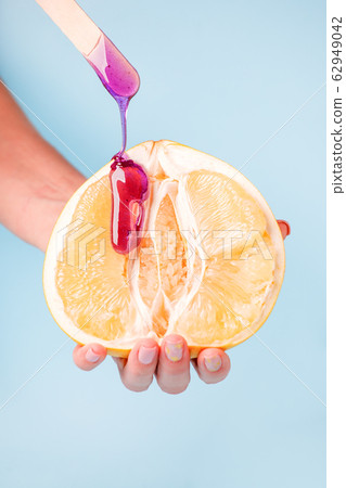 Half pomelo citrus and liquid wax. The concept of 62949042