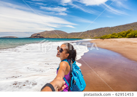 Galapagos tourists having fun on travel on Espumilla Beach, Santiago, Galapagos Galapagos tourists having fun on travel on Espumilla Beach, Santiago, Galapagos 62951453