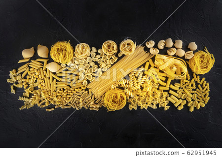 Italian pasta texture, a flat lay of a variety of pasta types, shot from above on a black background Italian pasta texture, a flat lay of a variety of pasta types, shot from above on a black background 62951945