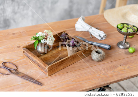 Set of gardener transplanting bulbous plants, hyacinths in cement pots on the wooden table. Concept of home garden. Flower and garden shop. Set of gardener transplanting bulbous plants, hyacinths in cement pots on the wooden table. Concept of home garden. Flower and garden shop. 62952553