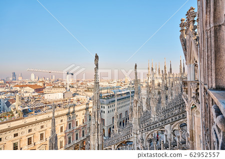 Amazing view of old Gothic spires. Milan Cathedral roof on sunny day, Italy. Milan Cathedral or Duomo di Milano is top tourist attraction of Milan. 62952557