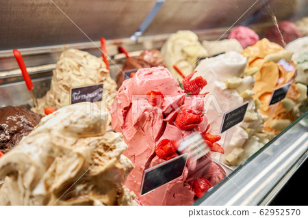 Fruit with strawberries Gelato. Flavors various ice cream in Rome, Italy. Italian gelateria. Assortment of colorful gelato on cafe showcase. Natural fresh ice cream. 62952570