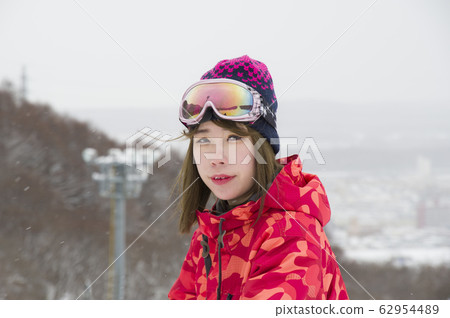 Ski slope and female skier who flutter light snow Ski slope and female skier who flutter light snow 62954489
