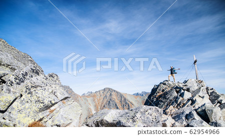Mature man with backpack hiking in mountains in autumn. Mature man with backpack hiking in mountains in autumn. 62954966