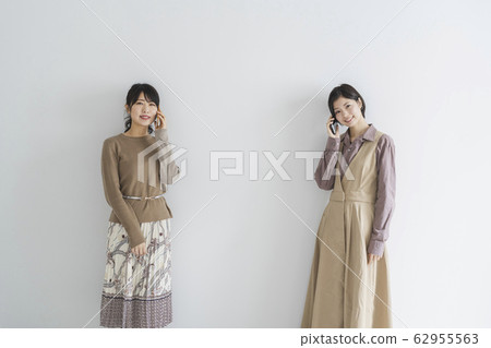 A woman using a mobile phone A woman using a mobile phone 62955563