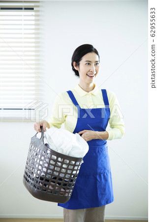 Housewife, middle and old aged with laundry basket Housewife, middle and old aged with laundry basket 62955633