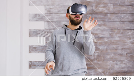 Caucasian home designer using virtual reality goggles Caucasian home designer using virtual reality goggles 62956809