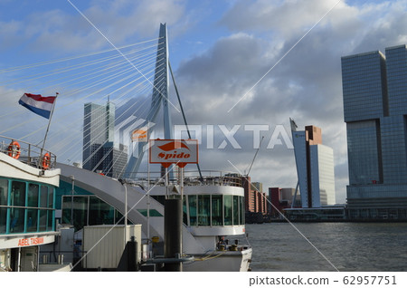 Rotterdam, Netherlands, Erasmus Bridge and tourist boat Rotterdam, Netherlands, Erasmus Bridge and tourist boat 62957751