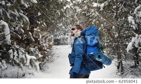 Hiker enjoying winter forest Hiker enjoying winter forest 62958041