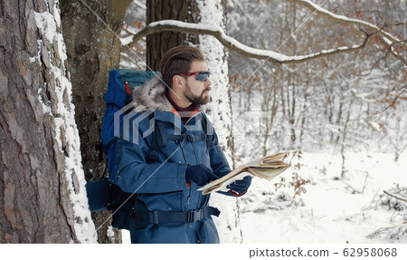 Backpacker consulting a map 62958068