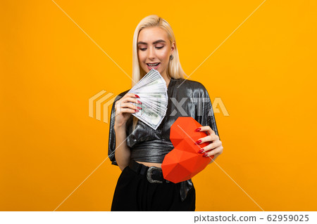 joyful girl won the valentine's day lottery on a yellow background with copy space 62959025