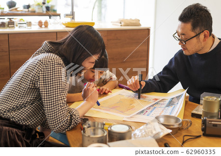 Family checking evacuation destinations while looking at the map Family checking evacuation destinations while looking at the map 62960335