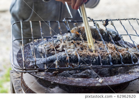 Grilling river fish with seven wheels 62962620