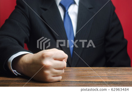 A businessman punched the table. End of patience. Impossible to bear it. An attack of anger, stress. A decisive, emotional gesture. That's enough! Choleric. Strictness and sociability, impulsiveness A businessman punched the table. End of patience. Impossible to bear it. An attack of anger, stress. A decisive, emotional gesture. That's enough! Choleric. Strictness and sociability, impulsiveness 62963484