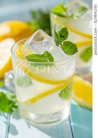 Lemonade and ingredients on blue wood background 62964280