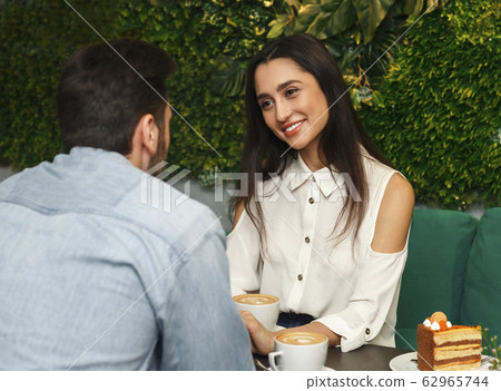 Girlfriend Smiling Flirting With Boyfriend On Romantic Date In Cafe Girlfriend Smiling Flirting With Boyfriend On Romantic Date In Cafe 62965744