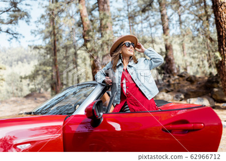 Woman traveling by car on nature 62966712