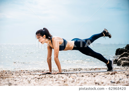 Young Asian woman practicing yoga exercise at Young Asian woman practicing yoga exercise at 62968420