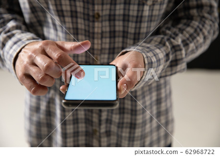 Caucasian woman using a smartphone Caucasian woman using a smartphone 62968722